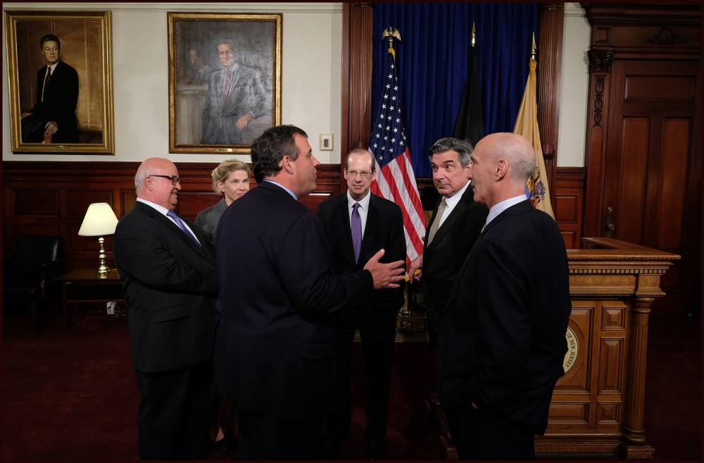 Governor Chris Christie joins New Jersey Supreme Court Chief Justice Stuart Rabner swearing in New Jersey Supreme Court Associate Justice Walter Timpone while Timpone's brother, Patrick Timpone, holds the Bible at the Statehouse in Trenton, N.J. on Monday, May 2, 2016. (Governor's Office/Tim Larsen)
